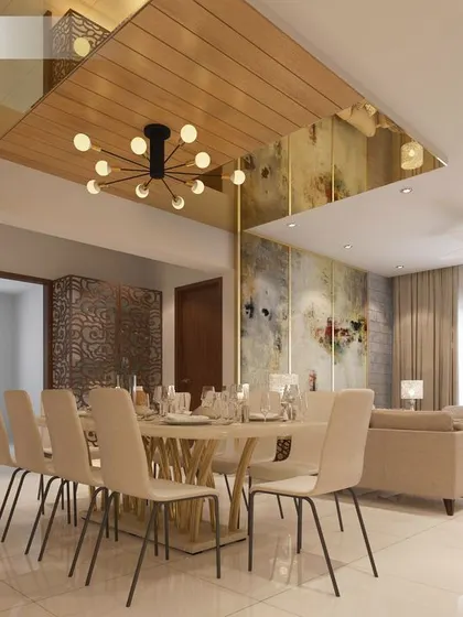 The dining room from our luxurious Cochin project. The stunning ceiling design with a modern chandelier and mirrored panels creates an exceptionally grand and opulent atmosphere.