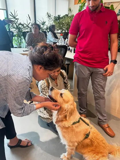 Positive interactions are key. Here, Coco is gently taking a treat, demonstrating the polite manners we practice throughout the puppy foundation program.