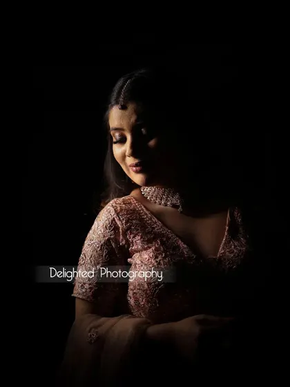 A beautiful low-key bridal portrait. The soft light just kisses her face and shoulder, creating a serene and elegant image against the dark background.