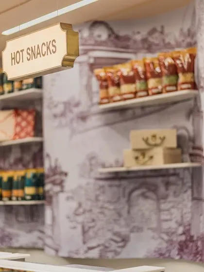 The curved wall behind the counter features artwork of the Gummanayaka fort, adding a layer of local Karnataka heritage to the store.