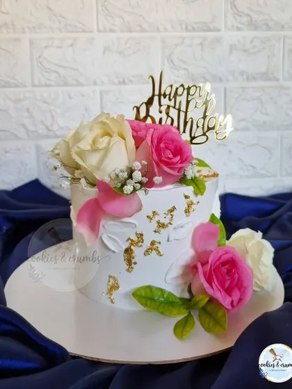 A beautiful floral cake is always a good idea. This design is loaded with fresh flowers and berries, creating a vibrant and lush look that's perfect for any celebration.