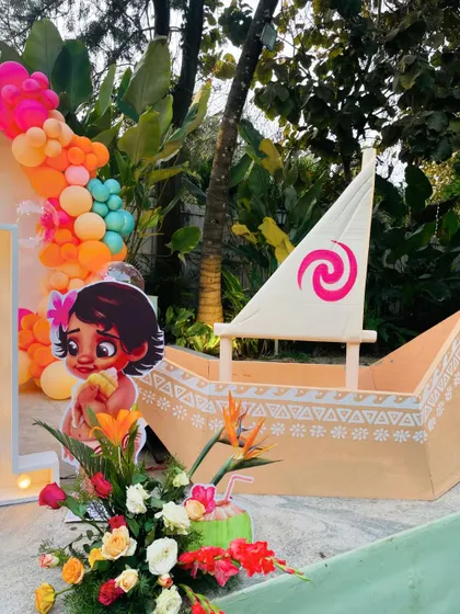 A close-up of the custom-made boat from the Moana party, complete with the iconic swirl on the sail.