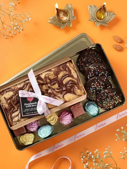 My luxury tin boxes can be customized. This one includes a tea cake and assorted handmade chocolates for a delightful mix.