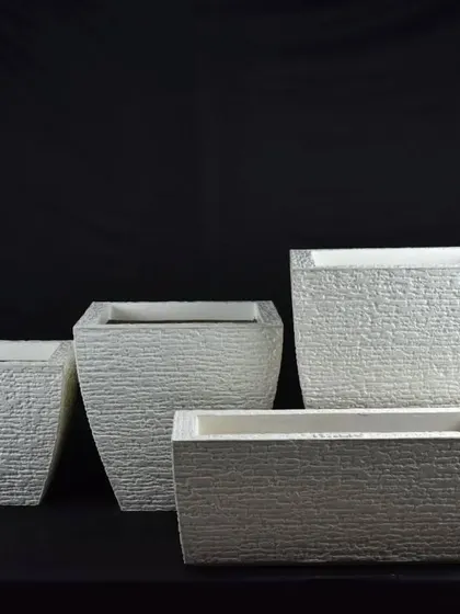 Textured white fiber planters in different shapes and sizes. The rough texture adds a unique, rustic feel.
