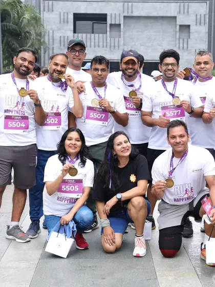 Posing with a group of runners proudly showing off their finisher medals. It's so rewarding to see their sense of accomplishment after the race.