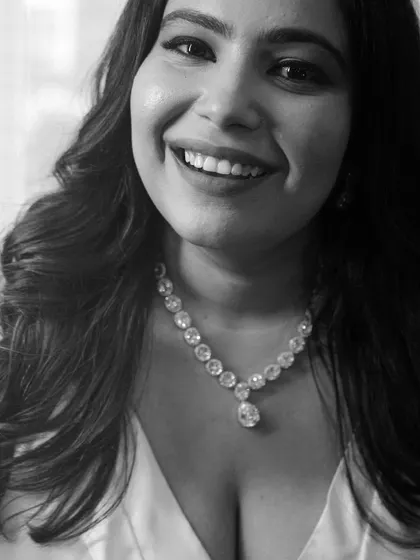 A striking black and white portrait that captures the bride's joyful smile and the classic beauty of her look.