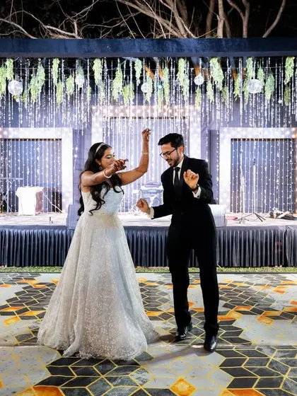 The couple's first dance on the beautifully lit stage. A classic and romantic moment.