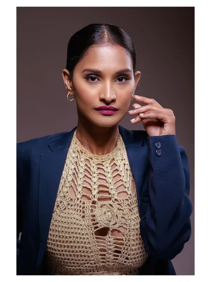 A polished and professional portrait of a model in a blazer. The lighting is clean and the expression is confident.