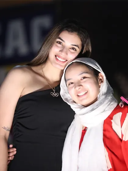 A senior athlete shares a warm moment with a junior student at our annual awards. This mentorship and camaraderie between athletes of all ages is what makes our academy special.