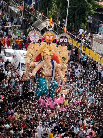 A shower of confetti over the Chinchpoklicha Chintamani procession. I focus on capturing these moments of pure joy and celebration that erupt spontaneously in the crowd.