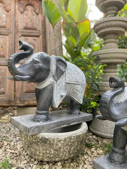 A view of one of our grand elephant statues, showing how it can be placed on a stone basin for an even more impressive display.