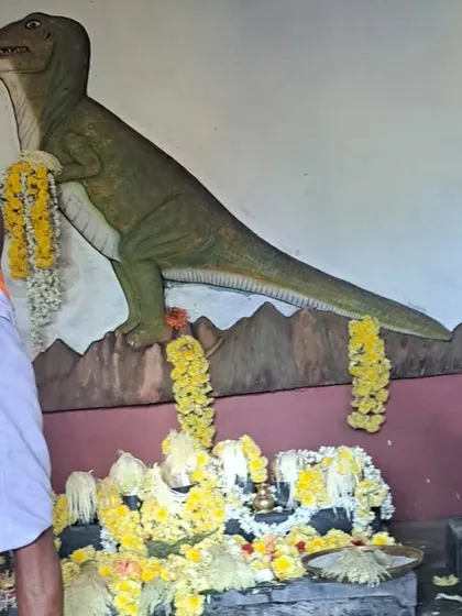 A mural of a dinosaur at the temple, a unique interpretation of the local 'mitili' legend.