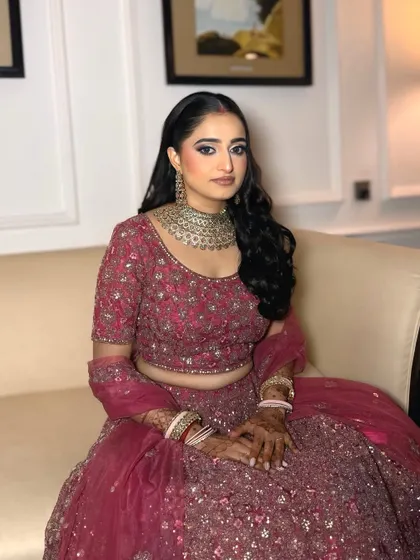 The complete reception look. The makeup perfectly complements her intricate lehenga and heavy jewelry without being overpowering.