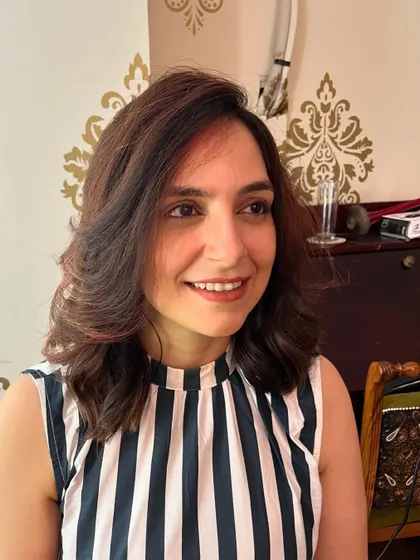 The copper tones add a touch of warmth to her dark hair.