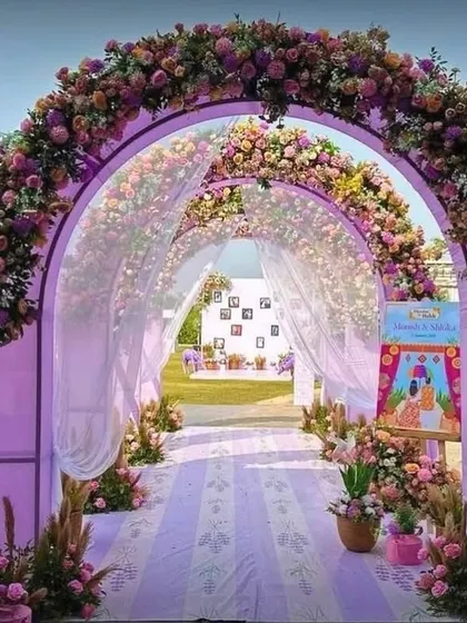 A grand entrance for a lavender-themed event, with floral arches and sheer drapes creating a beautiful and inviting walkway.