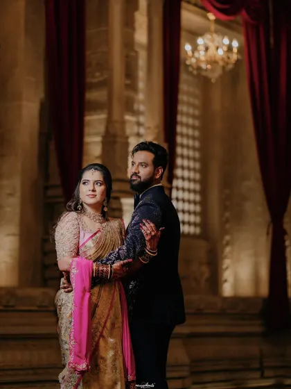 A dramatic and glamorous reception portrait. The makeup is sophisticated and elegant, perfect for a grand evening celebration.