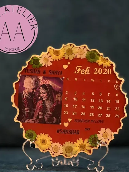 A classic red wedding date calendar frame, lit from behind to showcase its rich color. This piece is perfect for couples who want a bold and romantic keepsake.