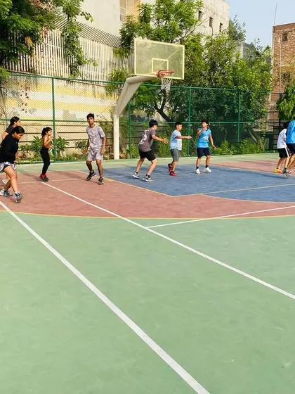 A full-court view of a training game, emphasizing spacing and player movement.