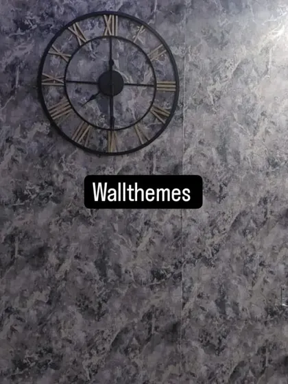 A textured grey wallpaper that mimics the look of stone or concrete, creating a modern industrial accent wall.