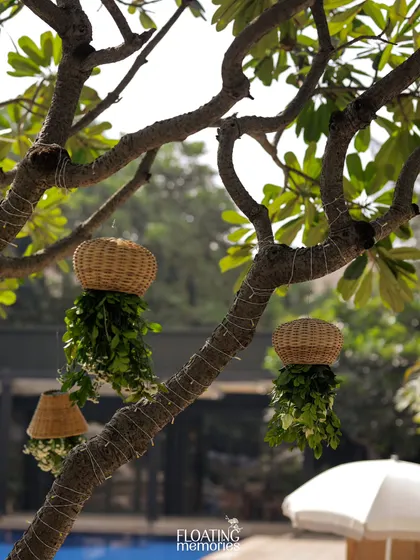 We use every part of the venue. Here, we hung custom wicker basket planters from the trees to enhance the natural, earthy feel of the safari.