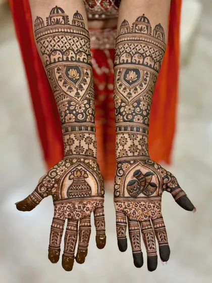 A stunning bridal design with a kalash and diya on the palms, surrounded by lotus and elephant motifs.