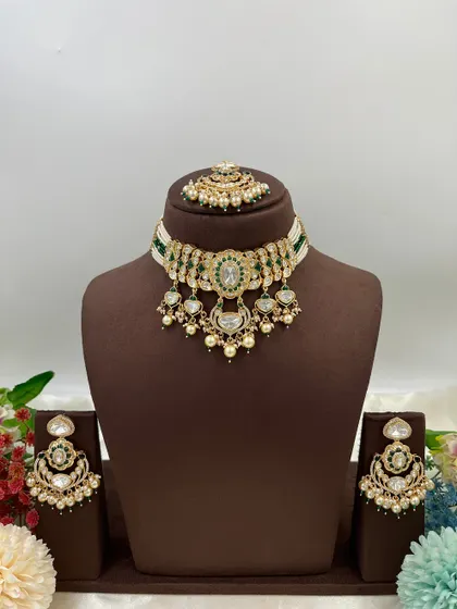 This collection showcases our premium Moissanite Kundan necklaces like the 'Noor Nazaakat' and 'Darbaar' sets. Each comes with a full set of earrings and maang tikka, available in various color combinations.