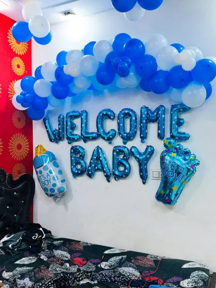 The 'Welcome Baby' decoration set up over a bed, creating a festive atmosphere in the room.