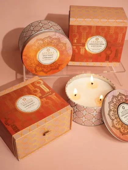 Our three-wick tin candles, shown here in Himalayan Cream and Wild Violet & Bergamot, are a gift of warmth and ambiance. The decorative tins and matching boxes make them a standalone present or a perfect addition to a larger gift set. in a stunning red glass jar. This set is a bold and beautiful statement, perfect for making any occasion feel special.