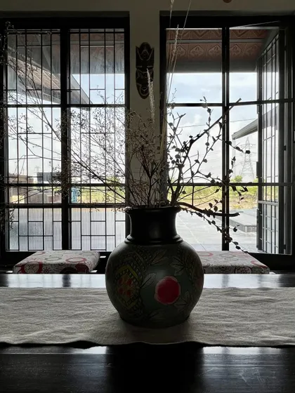 An interior view from the NallaNela farmhouse, looking out through the grilled windows. The decor is kept simple and rustic, in line with the home's purpose as a relaxed country retreat.