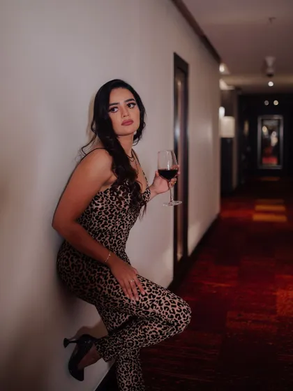 A duplicate of image 64, this sophisticated portrait of a model with a glass of red wine tells a story of luxury and style.