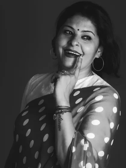 A playful monochrome portrait in a retro polka dot saree. Black and white photography adds a touch of nostalgia and classic charm.