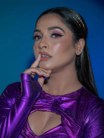 A close-up of the artistic makeup, showing the sharp lines and vibrant colors.