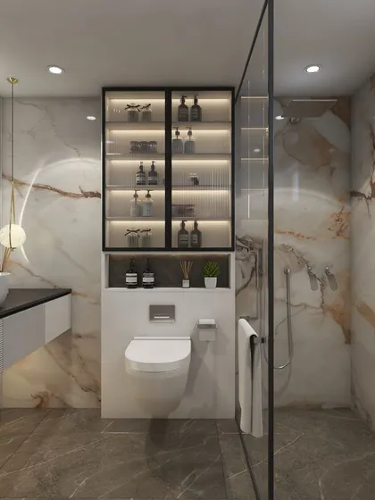 This angle shows the glass-enclosed shower area and the clever built-in storage cabinet above the toilet, which keeps the space organized and clutter-free.