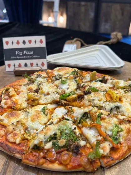 We also offer freshly baked Veg Pizza, a universal favorite. Topped with cheese and fresh vegetables, it's a perfect addition to any casual gathering or party menu.