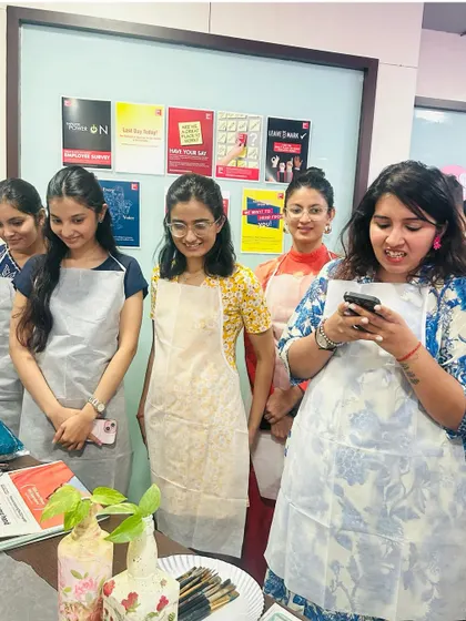 The team admiring their finished bottle art. It's always so rewarding to see the variety of designs and the pride in their creations.