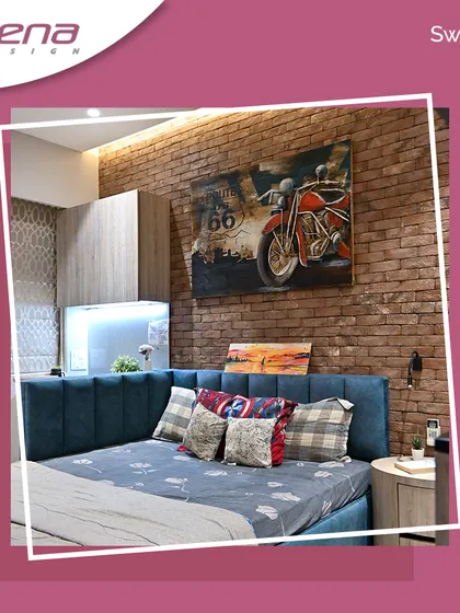 This bedroom has a rustic, industrial feel with an exposed brick accent wall. The custom bed with a blue upholstered headboard adds a pop of color and comfort.