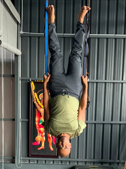 A slightly different angle of the inverted aerial pose, showcasing the control and balance involved.