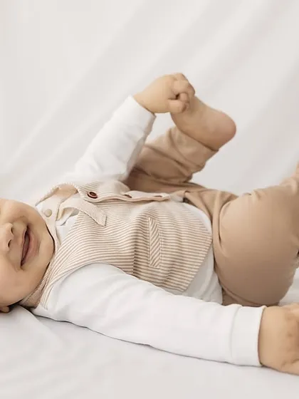 Playful and happy. This little one is kicking his feet, full of joy and energy during his half-birthday photoshoot.