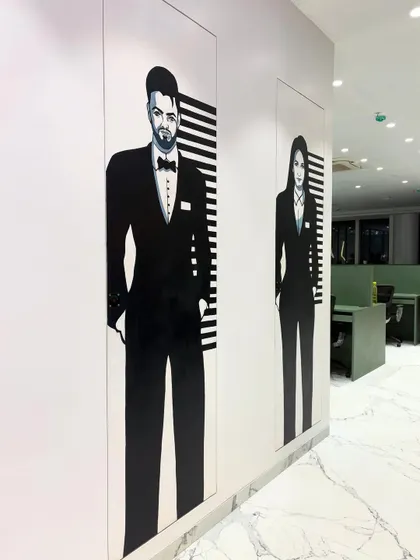 Art belongs everywhere, even in the washroom. I created these full-height, black and white painted murals to add a touch of unexpected style and personality to a corporate space.