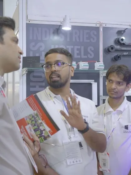 Explaining our product lineup to visitors at our booth. It's all about showing how my technology can solve real-world problems.