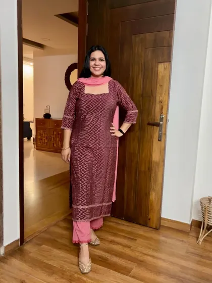 A beautiful printed suit in shades of pink and maroon. This is a versatile piece that can be worn for both casual and semi-formal events.