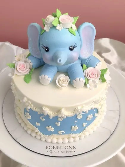 A top-down view of the charming baby elephant cake, highlighting the sweet floral details.
