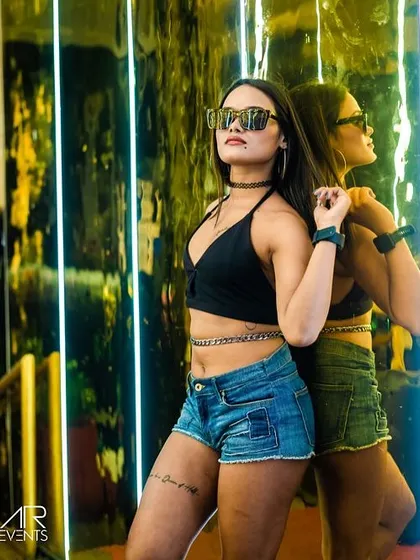 A cool, edgy shot of a guest at Sugar Factory. The venue's lighting and mirrors create fantastic photo opportunities.