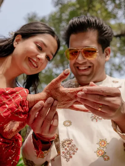 Aayush finds his name in Saanya's mehendi. This playful and traditional game is a great opportunity to capture close-up, interactive moments between the couple.