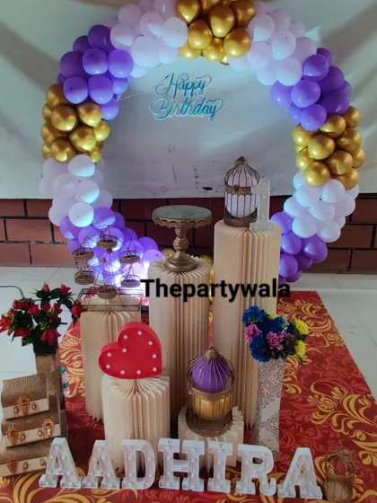 A purple, white, and gold balloon ring, creating a royal and elegant look.