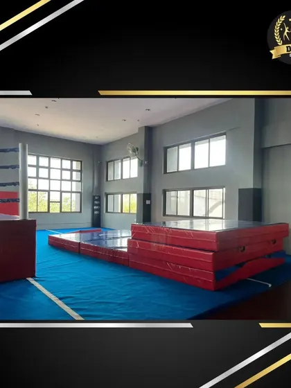 This side of the Fly Zone hall shows the stacked landing mats and open floor space, highlighting the versatility of the area for different training setups.