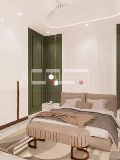 A bedroom design with a deep green accent wall, white wardrobes with gold handles, and soft pendant lighting for a sophisticated and calming feel.