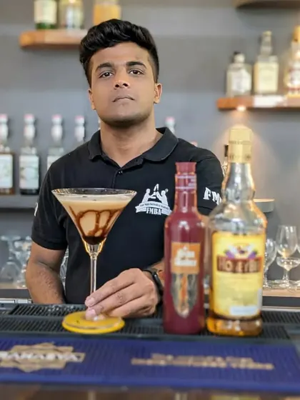 A bartender with a creamy, coffee-flavored martini, another one of our popular dessert cocktail options.