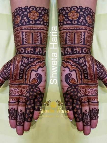 I design beautiful, coordinated mehendi for the entire bridal party. This full-hand design for the sister of the bride features bold peacock figures and traditional Indian patterns, ensuring the whole family looks and feels part of the celebration.