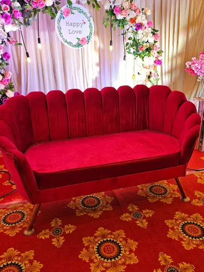 A close-up of the stylish red velvet sofa, a prop I can provide for your event.